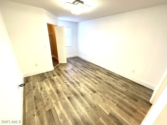 empty room with hardwood / wood-style flooring