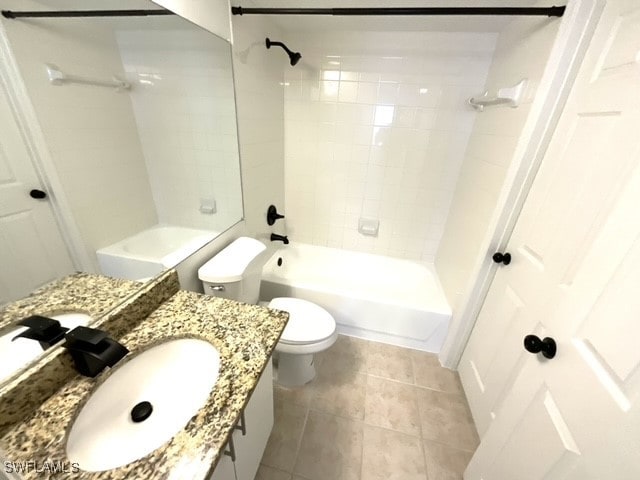 full bathroom with vanity, toilet, tiled shower / bath combo, and tile patterned flooring