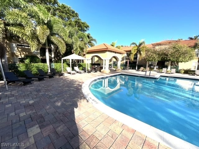 view of pool featuring a gazebo and a patio