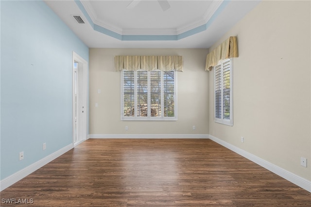 spare room with ornamental molding, a raised ceiling, ceiling fan, and dark hardwood / wood-style flooring