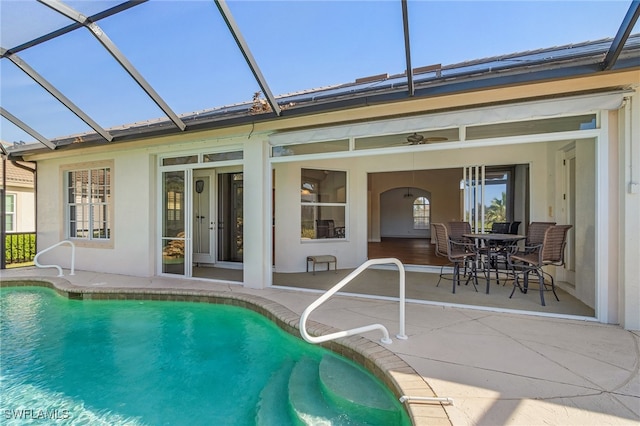 view of pool featuring a patio and glass enclosure