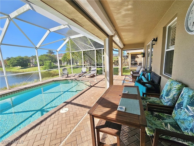 view of pool with a patio, a lanai, and a water view