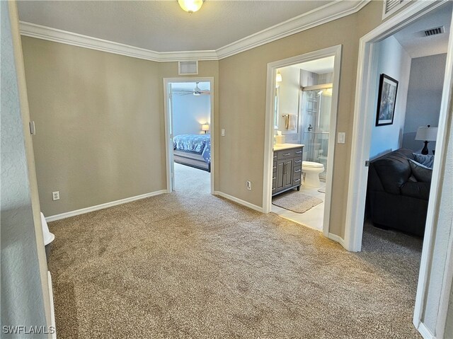 unfurnished room featuring ornamental molding, visible vents, and light carpet