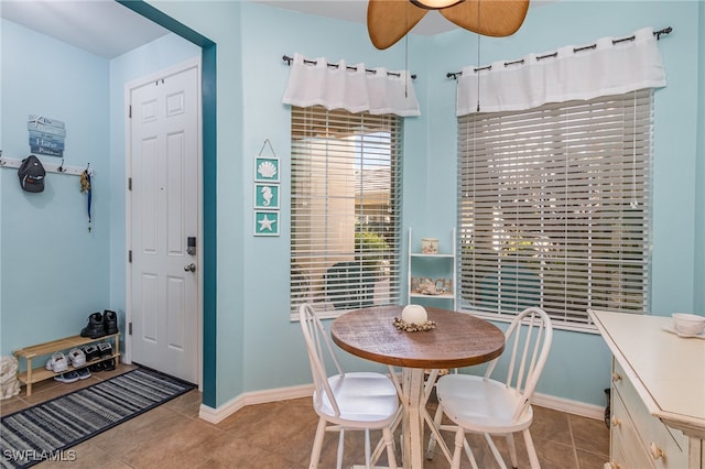 tiled dining space with ceiling fan