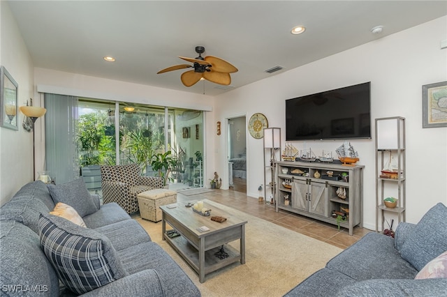 living room with ceiling fan and light tile patterned floors