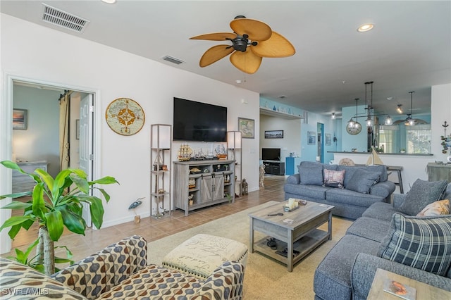 tiled living room with ceiling fan