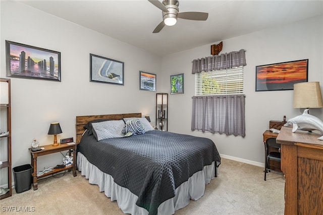 bedroom with ceiling fan and light carpet