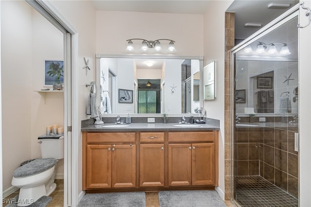 bathroom with toilet, walk in shower, and vanity