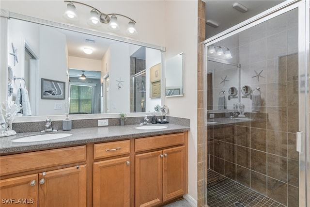 bathroom with a shower with door, vanity, and ceiling fan