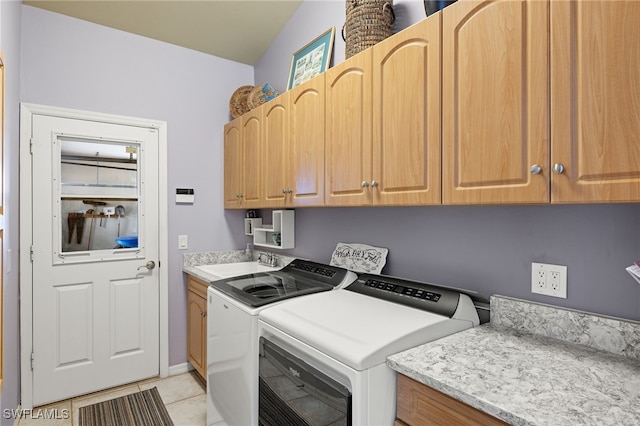 laundry room with sink, light tile patterned flooring, cabinets, and washer and clothes dryer