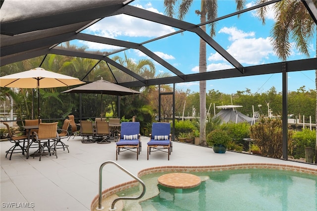 view of pool featuring a patio and glass enclosure