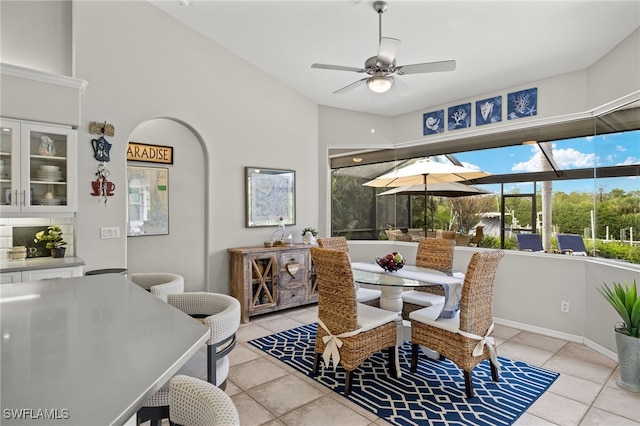 dining space with light tile patterned floors and ceiling fan