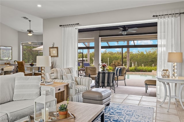 living room featuring a wealth of natural light, light tile patterned flooring, and ceiling fan