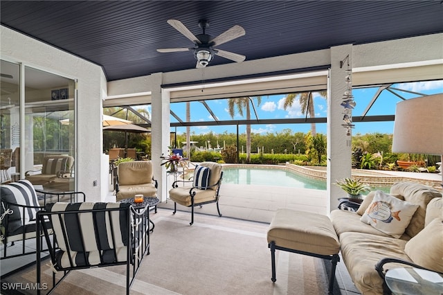 sunroom with a pool and ceiling fan