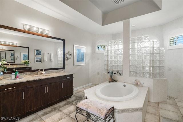 bathroom with vanity, tile patterned floors, and independent shower and bath