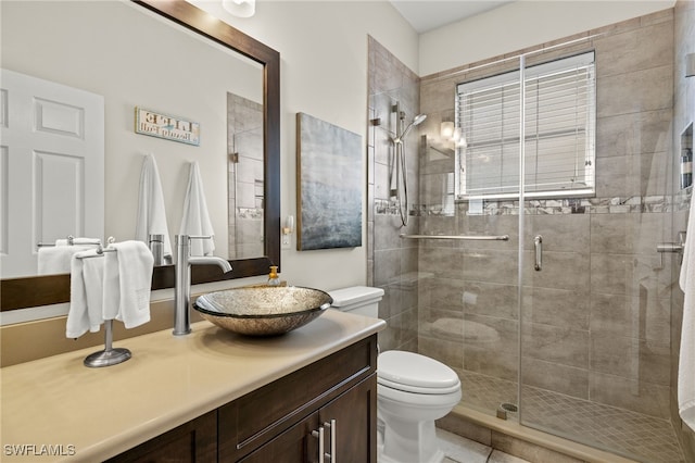 bathroom with toilet, an enclosed shower, vanity, and tile patterned flooring