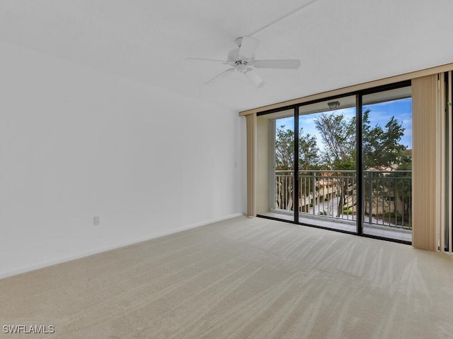 spare room with a water view, ceiling fan, and carpet