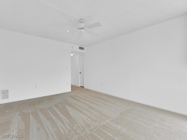 empty room featuring light carpet and ceiling fan