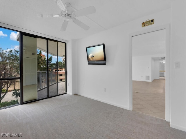 carpeted spare room with ceiling fan