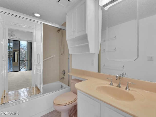 full bathroom with toilet, tiled shower / bath combo, a textured ceiling, and vanity