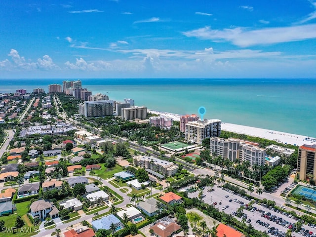 bird's eye view with a water view and a beach view