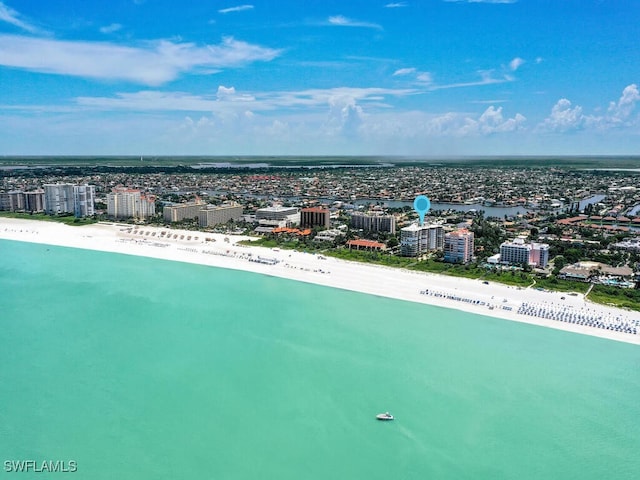 birds eye view of property with a water view, a view of the beach, and a city view