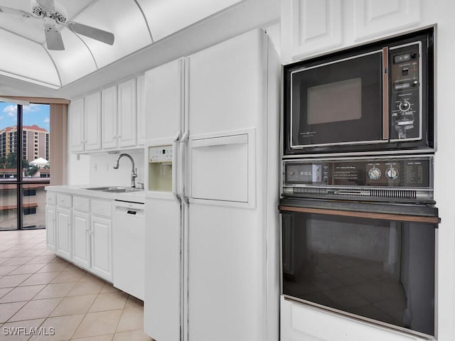 kitchen with white cabinets, ceiling fan, light tile patterned floors, black appliances, and sink