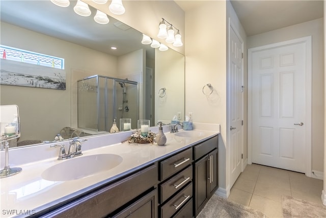 bathroom featuring a shower with door, vanity, and tile patterned flooring