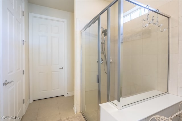 bathroom featuring tile patterned flooring and an enclosed shower