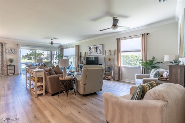 living room featuring a wealth of natural light, crown molding, light hardwood / wood-style flooring, and ceiling fan