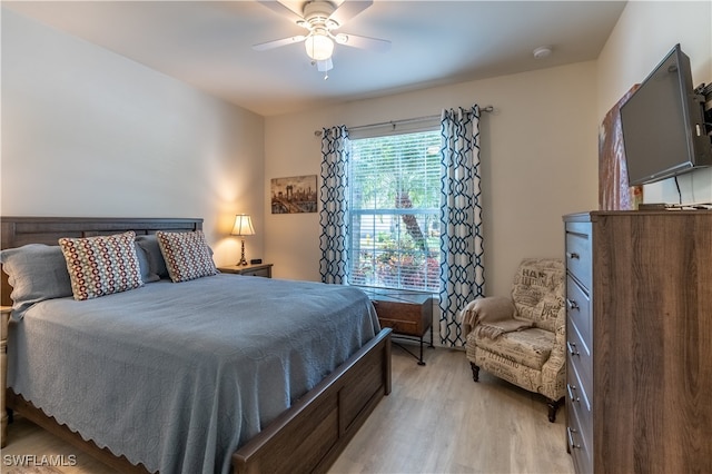 bedroom with light hardwood / wood-style flooring and ceiling fan