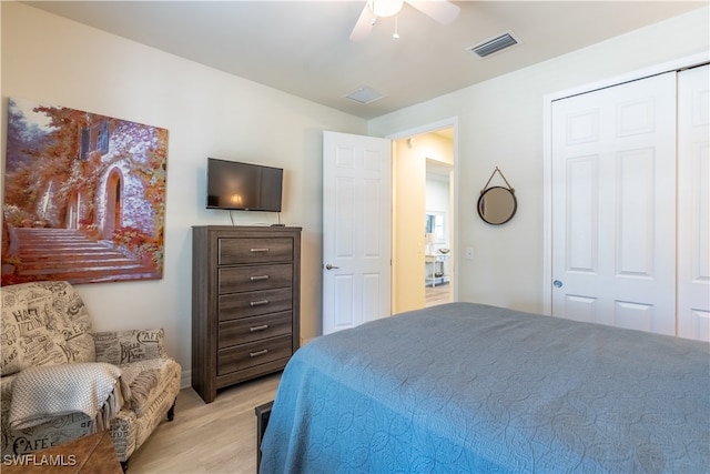 bedroom with light hardwood / wood-style floors, a closet, and ceiling fan