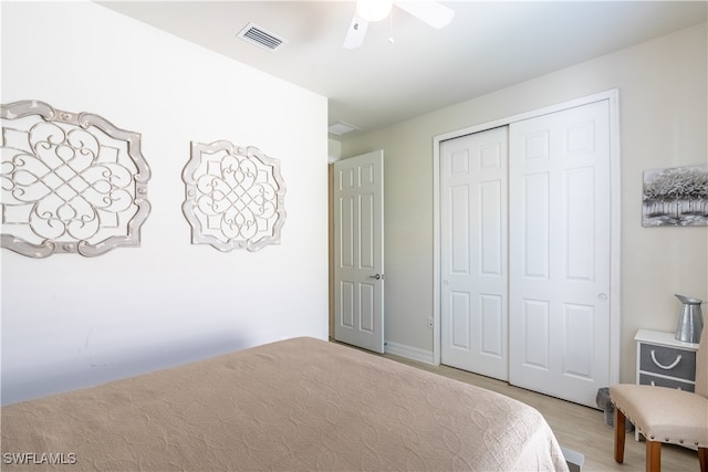 bedroom featuring light hardwood / wood-style flooring, a closet, and ceiling fan