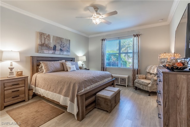 bedroom featuring light hardwood / wood-style floors, ornamental molding, and ceiling fan