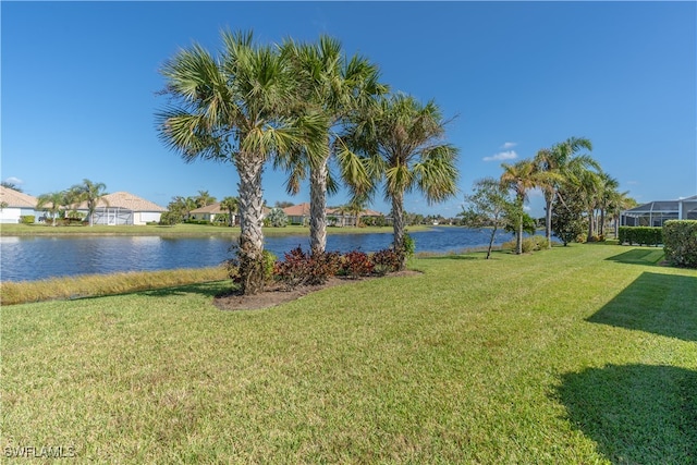 view of yard featuring a water view and a lanai