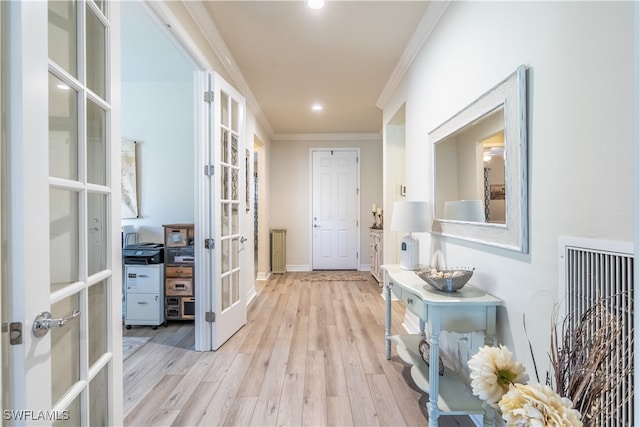 hallway featuring ornamental molding, french doors, and light hardwood / wood-style flooring