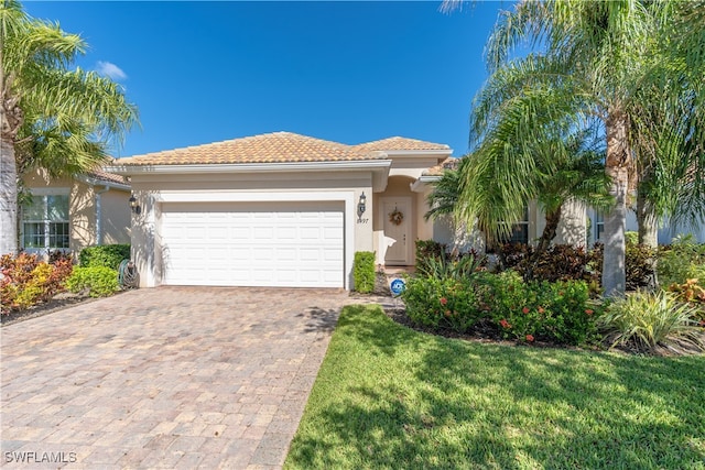 view of front of property featuring a front yard and a garage