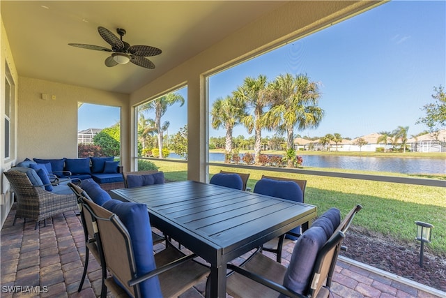 view of patio / terrace with a water view, ceiling fan, and outdoor lounge area