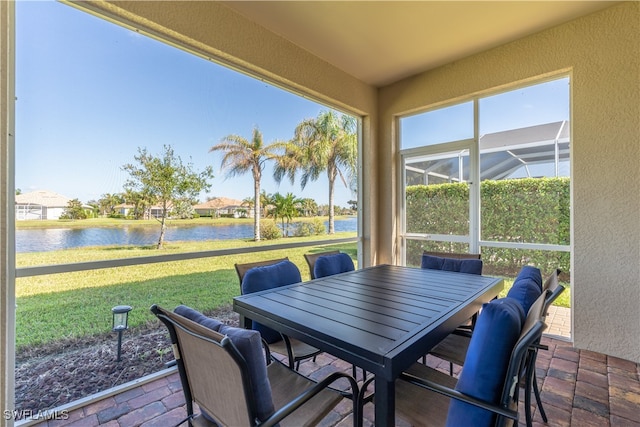 sunroom / solarium with a wealth of natural light and a water view