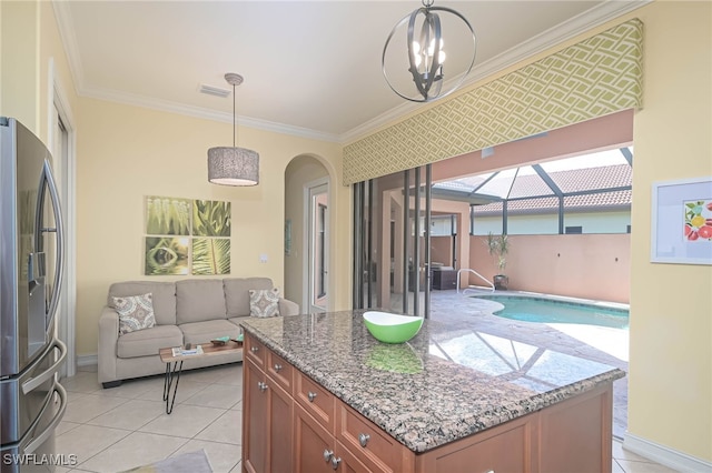 kitchen featuring ornamental molding, stainless steel refrigerator with ice dispenser, and pendant lighting