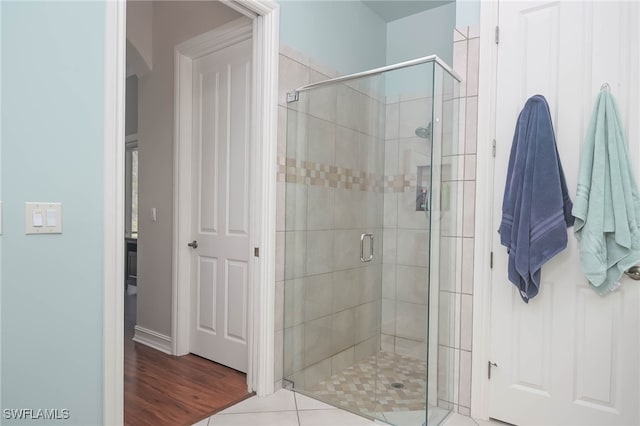 bathroom featuring an enclosed shower and hardwood / wood-style floors