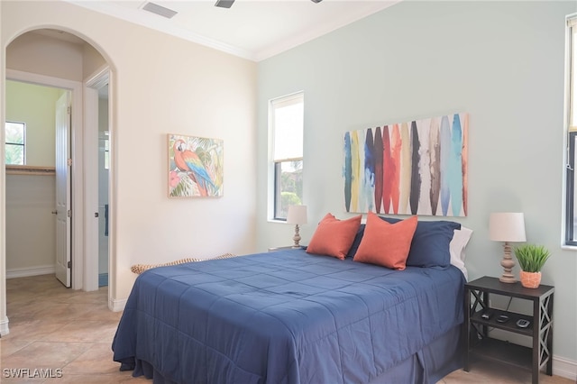 tiled bedroom featuring crown molding, multiple windows, and ceiling fan