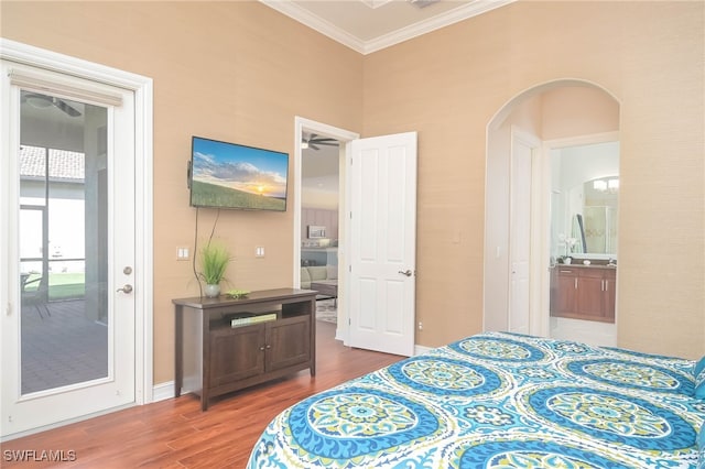 bedroom with ornamental molding, ensuite bathroom, and wood-type flooring