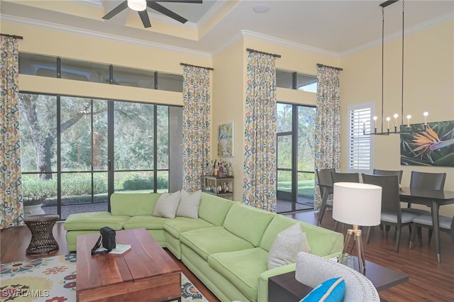 living room with ornamental molding, hardwood / wood-style flooring, and ceiling fan