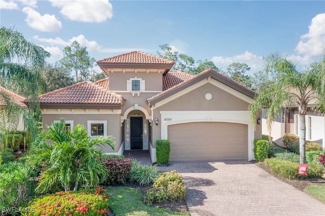 mediterranean / spanish-style home with a garage