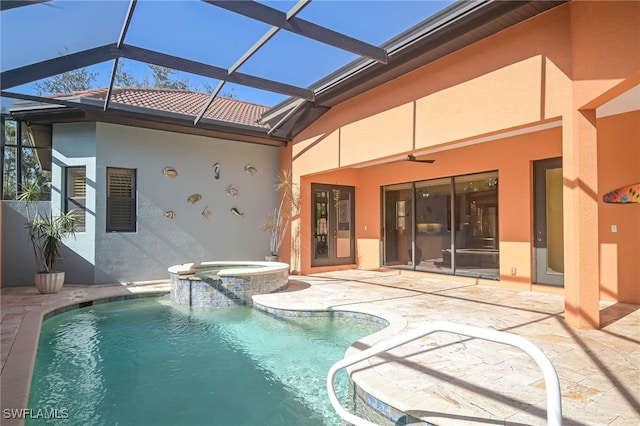 view of swimming pool with an in ground hot tub, a patio, glass enclosure, and ceiling fan