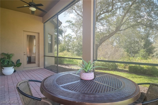 sunroom featuring ceiling fan