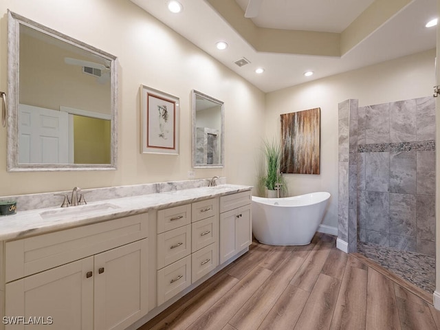 bathroom with vanity, hardwood / wood-style flooring, and independent shower and bath