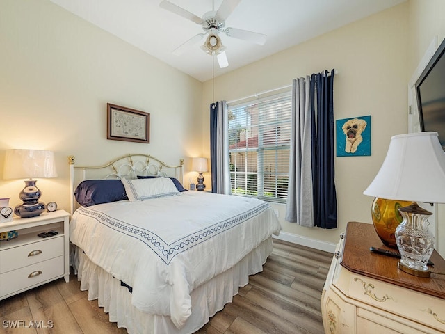 bedroom with ceiling fan and hardwood / wood-style flooring