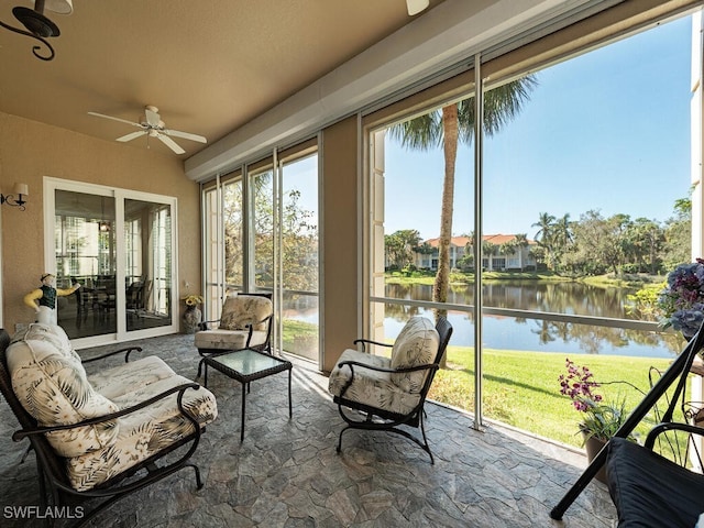 sunroom / solarium with a water view and ceiling fan